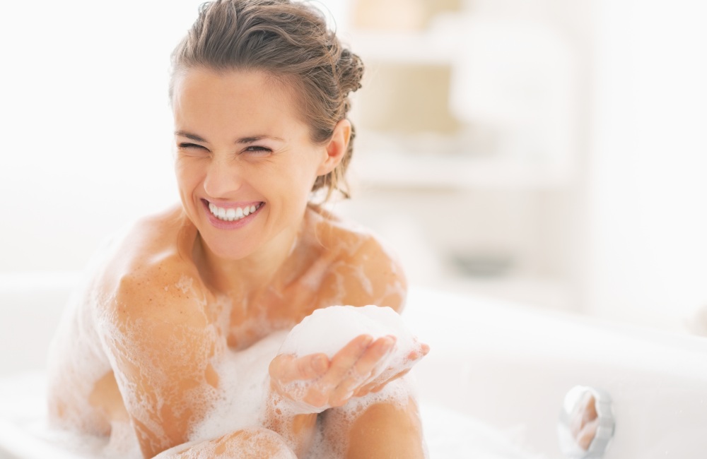 Happy woman taking a bath